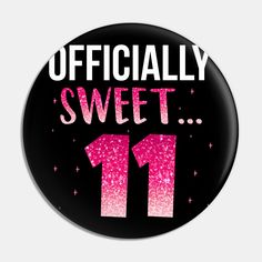 a black button with pink glitter on it that says officially sweet 11 1 / 4