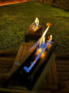 a fire pit sitting on top of a wooden table