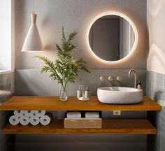 a bathroom with a sink, mirror and lights on the wall next to each other