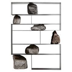 three metal shelves with rocks on them