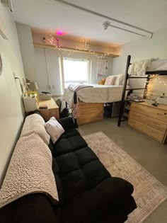 a dorm room with bunk beds and other furniture