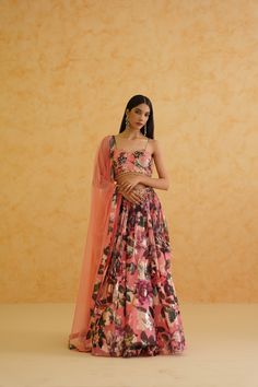 Elegant pink georgette lehenga with a gold crystal and sequin-embroidered floral blouse, styled with a delicate pink net dupatta for a sophisticated and glamorous look. Floral Print Georgette Choli With Traditional Drape, Georgette Choli With Floral Print And Traditional Drape, Party Anarkali Set With Floral Print And Traditional Drape, Festive Pre-draped Saree With Floral Print For Reception, Festive Floral Print Pre-draped Saree For Reception, Festive Floral Pre-draped Saree For Reception, Unstitched Floral Print Choli For Party, Bollywood Style Floral Print Georgette Lehenga, Pink Georgette Pre-draped Saree With Floral Embroidery