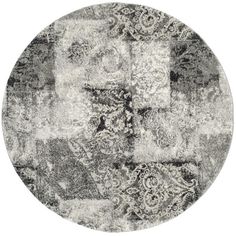 a round rug with an abstract design in grey and white colors on the bottom half