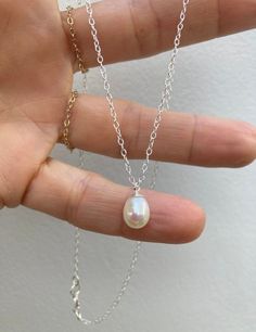 Beautiful and understated this necklace is timeless. D E T A I L S *It features an AA grade freshwater teardrop pearl with a lovely smooth and even nacre.  *Pearl measures around 8-8.5m *Choose between a 14k gold filled or 925 sterling silver chain.  *Necklace comes with an information card and is ready for gifting. C A R E * T I P To keep your necklace in good condition please avoid contact with water and remove when exercising or sleeping. Store away from heat, moisture and direct sunshine. T Dainty White Necklace With Pearl Drop, Dainty White Pearl Drop Necklace, Classic White Pearl Charm Necklaces, Minimalist Drop Pearl Necklace, Minimalist Pearl Teardrop Pendant Necklace, Minimalist Teardrop Drop Necklace With Pearl Charm, Everyday Teardrop Pearl Charm Necklace, Minimalist Drop Pearl Pendant Necklace, Minimalist Drop Pearl Chain Necklace