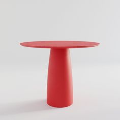 a red table sitting on top of a white floor