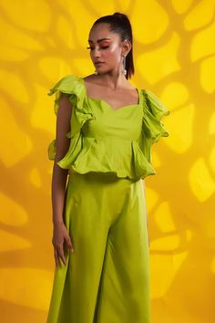 Green ruffle sleeved peplum top crafted in cotton. Paired with a matching cotton flared pant.
Components: 2
Neckline: Sweetheart
Sleeve Type: Ruffled
Fabric: Cotton
Color: Green
Occasion: Resort - Aza Fashions Cotton Ruffled Short Sleeve Peplum Top, Cotton Ruffle Peplum Top, Cotton Peplum Top With Ruffles, Chic Green Cotton Sets, Fitted Cotton Sets With Ruffles, Fitted Cotton Peplum Top With Ruffle Hem, Spring Ruffled Peplum Sets, Ruffled Fabric, Pant Women