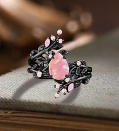 Unique Pear Pink Fire Opal Engagement ring Set Gothic Art deco Black Gold Cluster Vine Leaf Wedding Band Vintage Stacking Bridal Promise Set Applicable scene: anniversary, birthday party, wedding, engagement, gift ■ Handmade, high-quality item! ■ Material: S925 Sliver SOLID 14K/18K BLACK GOLD (can be made in white/rose/yellow gold) Engagement ring ■ Center stone: Pink Opal ■ Size/Weight: 6*8mm pear ■ Side stones: Pink Opal ■ Total weight: 0.042 ct (High Quality) ■ Cut - VG ■ Color: G-H ■ Clarity Unique Purple Engagement Rings, Black And Pink Wedding Rings, Ethereal Wedding Rings, Unique Opal Engagement Rings, Black Band Engagement Ring, Goth Wedding Rings, Flashy Engagement Rings, Wedding Band Stack Ideas, Black And Pink Wedding