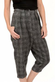 The classic newsboy pant, as seen through the Ivan Grundahl lens, Ence is done in a nubby plaid wool. It has a set-in waistband with a button/zipper closure, inverted pleats at the waistline, and an extended rise. Roomy through the hips, these pants taper to just above the ankle.ApproximatelyWaist Measurement: 15 inOutseam: 35 inInseam: 19 inFront Rise: 18 inBack Rise: 21 inLeg Opening: 7.5 in Pants have 2 front pockets. Tweed Pants With Pockets For Fall, Tweed Bottoms For Workwear In Fall, Fall Tweed Bottoms For Work, Fall Tweed Bottoms With Pockets, Fall Tweed Trousers, Winter Tweed Trousers, Classic Plaid Bottoms With Pockets, Plaid Tapered Leg Pants For Fall, Fitted Tweed Casual Bottoms