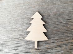 a wooden christmas tree ornament on a table