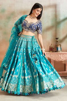 Go for a beautiful traditional look at weddings in this exquisite sea green embroidered Banarasi silk lehenga with blue embroidered blouse. The lehenga comes with a beautiful dupatta. Traditional Turquoise Choli With Resham Embroidery, Turquoise Lehenga For Navratri With Traditional Drape, Traditional Turquoise Choli For Reception, Anarkali Style Turquoise Lehenga With Pallu, Turquoise Lehenga With Traditional Drape For Navratri, Turquoise Bollywood Choli With Resham Embroidery, Blue Banarasi Silk Lehenga With Dupatta, Blue Anarkali Choli In Banarasi Silk, Traditional Blue Lehenga With Meenakari