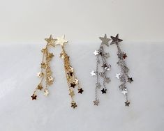 "more cute and fun necklaces and earrings in DearDanielleJewelry: https://www.etsy.com/shop/DearDanielleJewelry?ref=seller-platform-mcnav§ion_id=28417638 Shooting Star Earrings,Celestial Dangle Earrings. Star cascade, Star fall earring. Gold starry. Tiny sparkling little stars. 5/8\" diameter hammered gold plate star, 3\" drop Please choose your star color : Gold. Silver **framed gems, and charms in the jewelry is plated. *All the jewelry in my shop will be sent in cotton pouch. If you want gift Fall Earring, Star Earrings Dangle, Gold Star Earrings, Silver Star Earrings, Taylor Swift Tour Outfits, Earrings Star, Starburst Earrings, Earring Gold, Sparkly Earrings