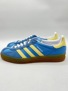 Elevate your sneaker game with these Adidas Gazelle Indoor Originals in size 10 for women. The blue and yellow colorway adds a pop of fun to any outfit, while the suede upper material ensures both style and durability. Whether you're running errands or hitting the gym, these athletic sneakers are the perfect fit. The Adidas Gazelle is a classic model that never goes out of style, and this pair in particular (style code IE2960) is a must-have for any sneakerhead. Adidas Gazelle Indoor, Sneaker Games, Adidas Gazelle, Athletic Sneakers, Blue And Yellow, Sneaker Head, Adidas Women, Blue Yellow, Womens Sneakers