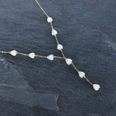 Gorgeous Pikake mother of pearl station necklace. These Pikake are not plastic, they are hand carved from real mother of pearl. Length measures around the neck - please select the length that suits you best. (The length does not include the dangling part of the necklace) A perfect, delicate touch to elevate your outfit. In your choice of gold fill or sterling silver. This material will not tarnish, and can even get wet! Delicate Mother Of Pearl Necklace For Wedding, Delicate White Mother Of Pearl Necklace, Dainty Mother Of Pearl Jewelry For Wedding, Delicate Adjustable White Drop Necklace, Handmade White Briolette Necklace, Delicate White Adjustable Drop Necklace, White Heart-shaped Mother Of Pearl Jewelry, Delicate White Mother Of Pearl Jewelry, Delicate White Briolette Necklace