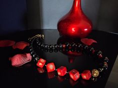 Beautiful handmade necklace with natural red coral cubes(10mm), black agate pearl beads and hematite beads. All metal components are 18K gold plated. The necklace is 47 cm long, is a crew neck and has an adjustable golden steel clasp with a 5 cm extension. The necklace is asymmetrical, very beautiful due to the contrast of the red and black colors and the shape of the beads - cubes and rounds. The necklace is very elegant, very beautiful in summer with a low-cut dress. It recalls the sea, the sun... for those who love nature. A beautiful gift for her All jewels are delivered in a decorated box, ready to be given as a gift to your loved one. How to take care of your jewellery: put on your beauty products (cosmetics, perfumes, ...) before wearing your precious jewel. Clean your jewelry with Luxury Red Coral Necklace Gift, Gift Red Coral Necklaces With 8mm Beads, Luxury Black Beads Necklace For Gift, Red Onyx Jewelry For Gift, Red And Black Necklace, Low Cut Dresses, Necklace Elegant, Cut Dress, Natural Coral