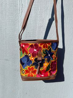 *Please advise each bag has a different design and color background. It might not be the exact flowers/ color background as the image. If you want a specific design please message us for photos* The vibrant embroidered flowers that are carefully crafted by artisans in Mexico bring beauty to this bag. You can style this as a shoulder or crossbody bag for any occasion.Measurements: 10 inches (width) x 8 1/2 (length)Made with Synthetic Faux Leather-Adjustable straps-Zipper closure pocket-Back Zippe Hippie Purse, Flowers Color, Navy And Brown, Color Background, Charcoal Color, Embroidered Flowers, Colorful Flowers, Zipper Pocket, Adjustable Straps