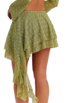 A spiral frill cascades from the side of this beachy, tiered miniskirt textured with an intricately knit pattern and lined with stretchy jersey. Pull-on style Lined 100% polyester Dry clean Imported Green Tiered Beach Skirt, Tiered Green Beach Skirt, Green Tiered Skirt Skort With Ruffles, Green Tiered Ruffle Skort, Beach Mini Skort With Ruffled Skirt, Ruffled Mini Skirt For Beach, Green Ruffled Tiered Skirt Skort, Green Ruffled Tiered Skort, Beach Mini Ruffled Skort