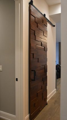 a room with a wooden door and white walls