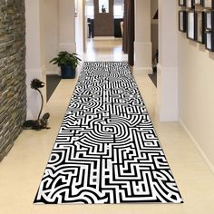 a black and white rug on the floor in a hallway