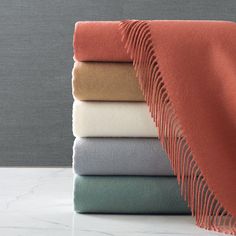 a stack of folded sheets sitting on top of a table