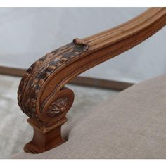 an ornate wooden arm rest on a chair