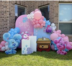 there are balloons and toys in front of the house for children's birthdays