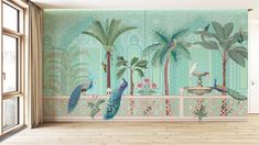 peacocks and palm trees are painted on the wall in an empty room with wooden floors