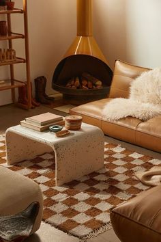 a living room filled with furniture and a fire place in the middle of the room