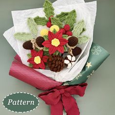 a bouquet of crocheted poinsettias and pine cones wrapped in paper