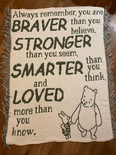 a cross stitch blanket with the words braver, stronger and loved on it