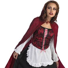 a woman wearing a red and white top with black skirt, cape and boots is posing for the camera