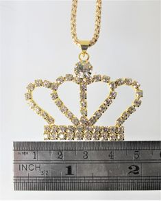 Gold or Silver Jewel Encrusted Crown Pendant, These crown necklaces are perfect for all royalty with all their rhinestones. They would make an exceptional gift for a fashionista. They are exquisite and would make an excellent charm or just as a collectible for the designer at heart. The are about 1.5 in x 2 in and they come with a 28" chain. Gold Crystal Crown Jewelry, Gold Crystal Crown Shaped Jewelry, Costume Jewelry With Rhinestones For Gifts, Gold Jeweled Crown Jewelry, Costume Rhinestone Necklace For Gifts, Costume Jewelry With Rhinestones Made Of Cubic Zirconia, Jeweled Crystal Rhinestone Necklace As Gift, Gold Cubic Zirconia Crystal Necklaces For Party, Silver Regal Jewelry For Gift