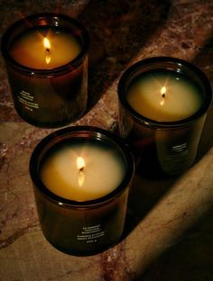 three candles sitting on top of a table