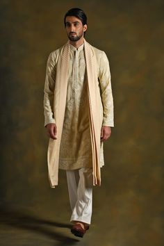 True beige kurta with floral motif thread embroidery. Comes with matching stole and white pant. - Aza Fashions Beige Sherwani With Dupatta Traditional Drape, Cream Kurta With Dabka Embroidery, Beige Raw Silk Traditional Wear With Dabka, Beige Raw Silk Kurta With Naqshi, Beige Raw Silk Traditional Wear For Ceremonies, Beige Festive Kurta With Traditional Drape, Cotton Silk Sherwani With Dupatta, Beige Sherwani With Chikankari Embroidery, Wedding Cotton Silk Sherwani With Naqshi