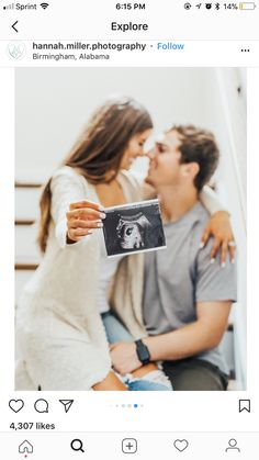 a man and woman kissing while holding up an instagramr to show them their love