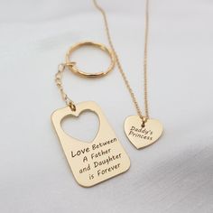 two personalized gold key chains with heart tags