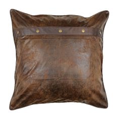 a brown leather pillow with rivets on the front and back, isolated against a white background