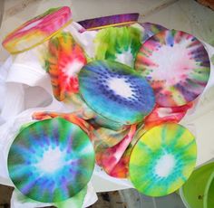 several different colored plates sitting on top of a table