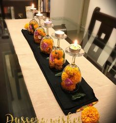 a long table with candles and flowers on it