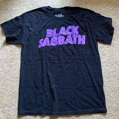 Black Sabbath New Without Tags T-Shirt Black Band Logo T-shirt With Relaxed Fit, Black Band Logo T-shirt In Relaxed Fit, Black Band Logo T-shirt Relaxed Fit, Black Relaxed Fit T-shirt With Band Logo, Black Band Merch T-shirt With Logo, Black Logo Print Top For Concert, Black Crew Neck Alternative Shirt, Black Band Logo T-shirt For Concert, Black Band Logo Crew Neck Top