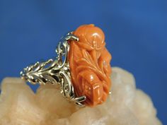 We offer free sizing, free shipping in the USA only, and a free appraisal upon request. If you are an international buyer, please contact us to work out shipping price. Also, we do not pay customs fees. Thanks. Sku: MJ1018 This is a 11.25 ct. Hand-Carved Pink Coral gemstone ring. This is a natural floral Coral in a sterling silver .925 setting. The ring was made in the USA by our staff gemologist and jeweler. Every ring is unique and one of a kind. The beautiful Coral is 14 mm x 22 mm. The total Formal White Gold Carved Jewelry, Carved White Gold Rings For Formal Occasions, Elegant Carved Orange Jewelry, Elegant Orange Carved Jewelry, Formal Carved Fine Jewelry Rings, Coral Gemstone, Floral Ring, Ring Art Deco, Sterling Silver Filigree