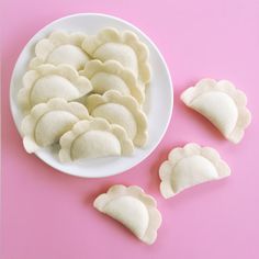 several pieces of heart shaped cookies on a white plate next to it's cut ones