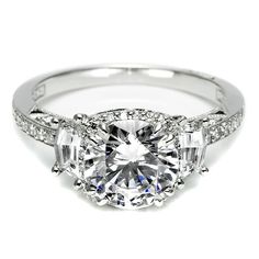 a diamond engagement ring with three stone accents