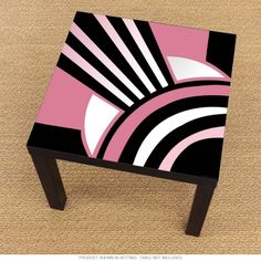 a pink and black table sitting on top of a carpeted floor