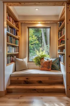 a window seat in the corner of a room with bookshelves on both sides