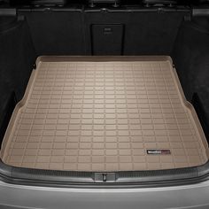 the trunk area of a car with its cargo compartment open and it's floor mat folded down