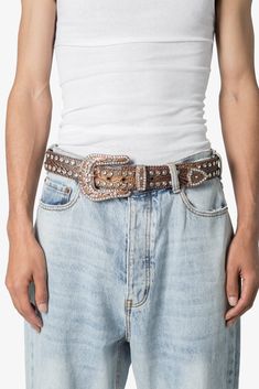 the Double Row Studded Belt is made from black leather and features intricate studded design motifs on the metal buckle, end tip and loop, with white rhinestone embellishment throughout the belt. Design Details 100% leather metal buckle and trims S/M fits waists 32" - 36" M/L fits waists 36" - 40" Design Motifs, Belt Design, Studded Belt, White Rhinestone, The Double, Metal Buckles, Bald Eagle, Design Details, The Row