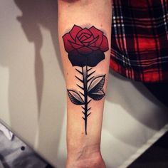 a woman's arm with a rose tattoo on it