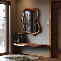 a mirror sitting on top of a wooden shelf next to a window in a room