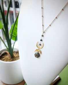 This crystal necklace is handmade with a hexagonal  labradorite briolette, two 18k gold plated stainless steel crescent moons, larkivite beads, and hypoallergenic gold plated stainless steel satellite chain.  Necklace length: 18 inches + 2.5 inch extender Pendant height: 2.5 inches Benefits of Labradorite: ♡ Imparts strength and perseverance  ♡ Balances and protects ♡ strengthens intuition and discernment Benefits of Larkivite: ♡ Subtle cleansing properties ♡ Connects one to the earth ♡ Stimulat Gold Labradorite Jewelry With Moon Charm, Gold Crescent Wire Wrapped Necklaces, Gold Jewelry With Labradorite Moon Charm, Gold Jewelry With Moon Charm And Labradorite, Labradorite Moon Shaped Necklace With Moon Charm, Labradorite Moon Charm Necklace, Mystical Moon Phase Labradorite Necklace, Labradorite Necklace With Moon Charm For Healing, Labradorite Moon Charm Jewelry For Healing