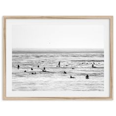 black and white photograph of surfers in the ocean